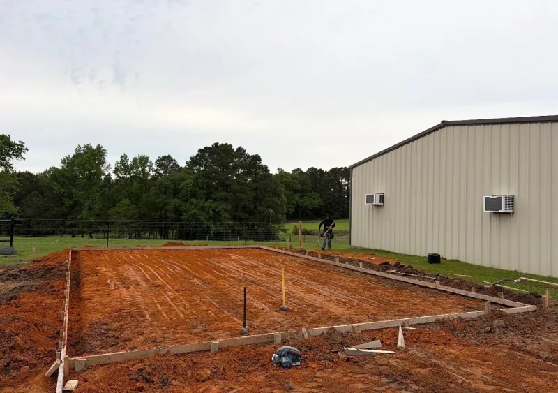 Pad formed beside a metal building